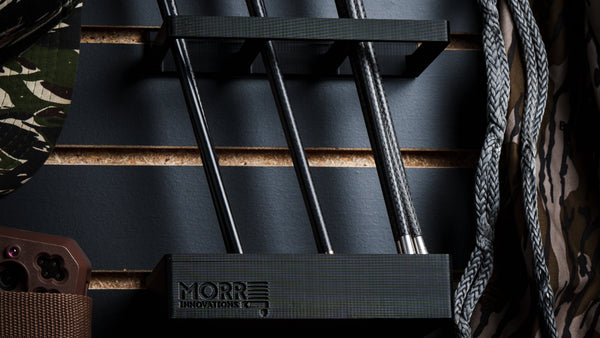 Slat Wall Arrow Quiver mounted on black slatwall with carbon hunting arrows